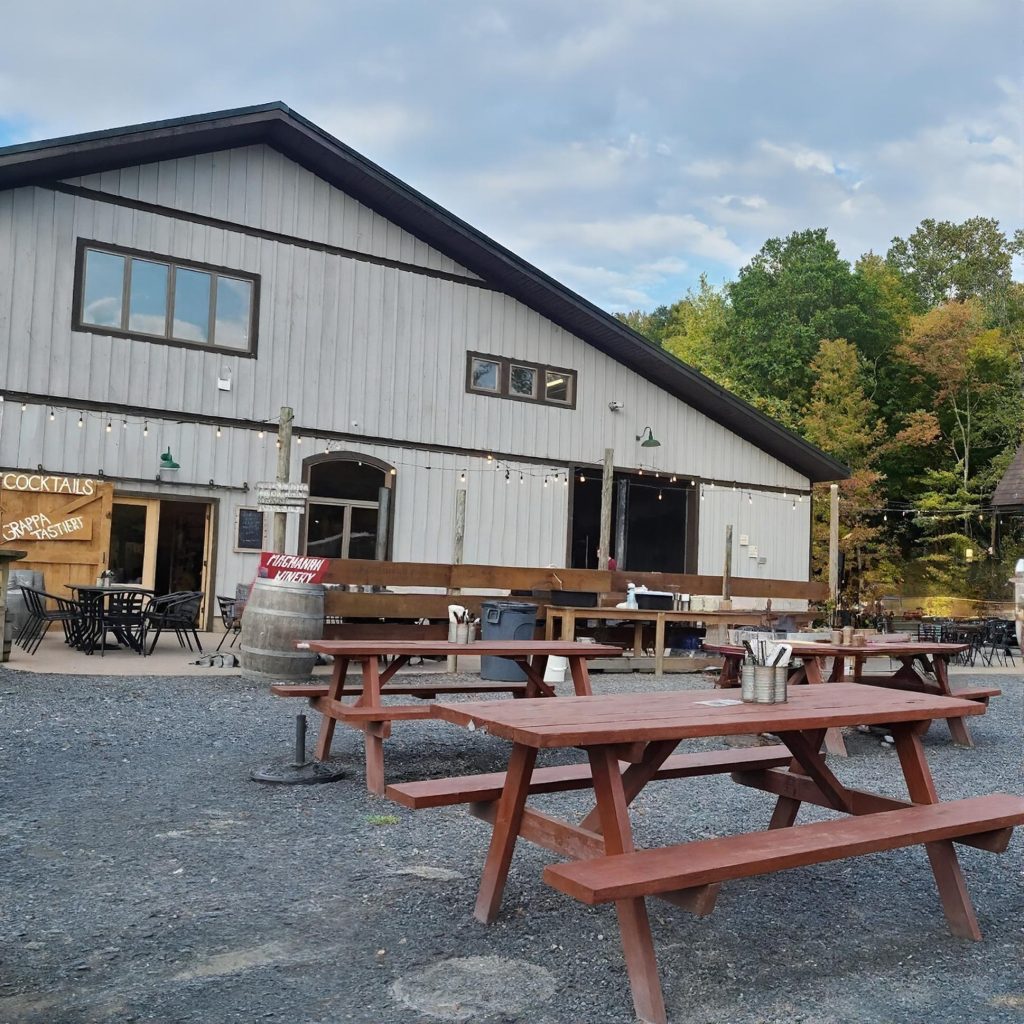Outdoor tables at Magnanini Winery in the Hudson Valley during a chauffeured wine tasting tour from Long Island.