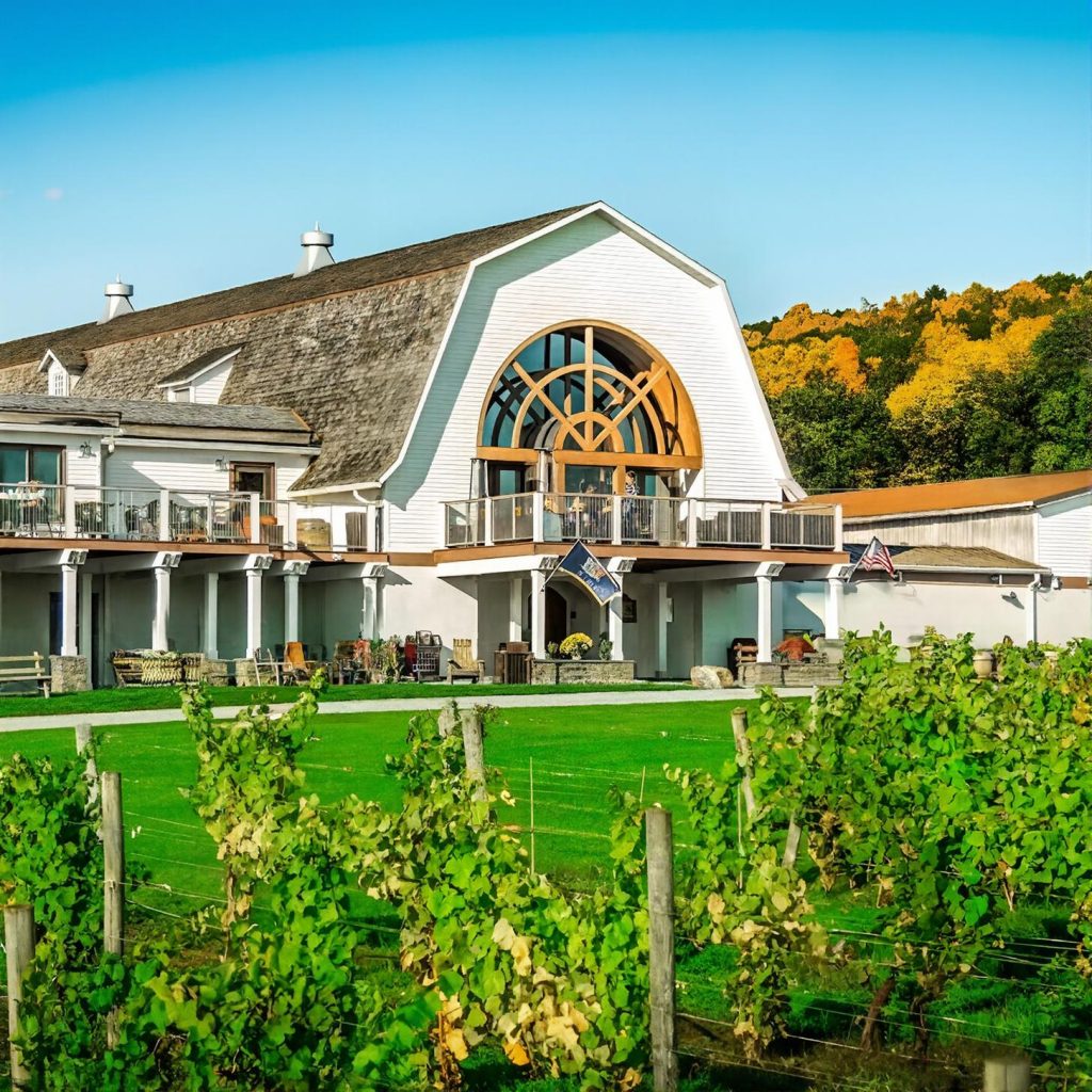 View of the winery house at Millbrook Vineyards from the vineyard during a chauffeured wine tasting tour from Long Island.